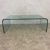 A vintage bent plate glass coffee table. H.37 W.111 D.60cm.