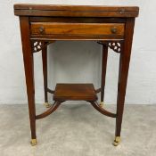 A Edwardian mahogany card table with envelope swivel top action fitted with frieze drawers above