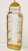 A contemporary wall or pier mirror in a gilt metal birdcage style frame fitted with base shelf.
