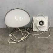 A mid-century Italian Conchiglia table lamp with white acrylic shade raised on a bent chrome