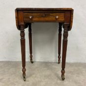 A Regency rosewood Pembroke table with two drop leaves over the single frieze drawer and opposing