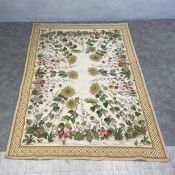 A Chinese Aubusson style needlepoint carpet with floral designs over a beige ground within a