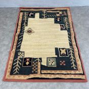 A Persian Gabbeh rug with abstract foliate designs over a beige ground within a repeating