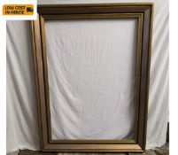 A large gilt painted picture frame. 146x110cm.