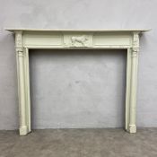 A 19th century carved and painted fire surround with egg-and-dart moulded cornice over the figural