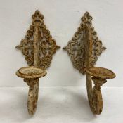 A pair of C.1900 painted cast iron wall mounted openwork candle holders or wall sconces. H.50cm.