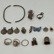 A mixed lot of silver to include three hallmarked rings, two pendants, a thimble, enamelled brooch