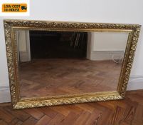 A contemporary gilt framed wall mirror with bevelled plate. 95x66cm.