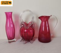 Three items of cranberry glass, one signed. H.20cm (Tallest).