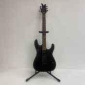 A Dean Vendetta electric guitar with stand. H.99cm.