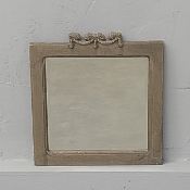 A small contemporary composite resin stone effect wall mirror with square bevelled plate and garland