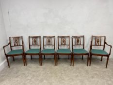 A set of six mahogany dining chairs in the Regency style each having an openwork back and reeded