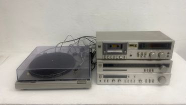A vintage Technics turntable with integrated amplifier, tuner and cassette deck.