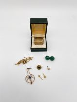 A mixed lot of yellow metal to include a large step cut smoky quartz brooch together with a bar