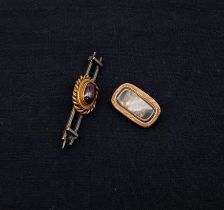 A yellow metal bar brooch with red cabochon stone together with a yellow metal mourning brooch