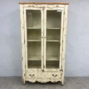 A contemporary French Provincial style open bookcase or display vitrine in a distressed painted
