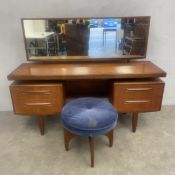 A mid-century teak dressing table with rectangular mirror over and arrangement of four drawers