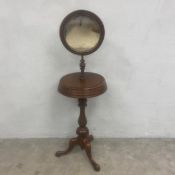 A C.1900 gentlemen's mahogany shaving stand having a circular mirror with original plate over two