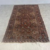 A Persian Khamseh rug with stepped bird and flower decorated lozenges over a midnight ground