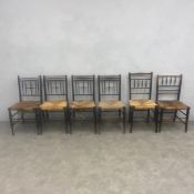 A set of four Victorian turned and ebonised Arts & Crafts 'Argyll' chairs with rush seats by Ford