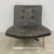 A mid-century Westerham lounge chair with black leather upholstered deep-buttoned back and seat
