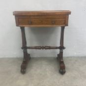 A 19th century rosewood games and work table with revolving top hinged to reveal inlaid chess and