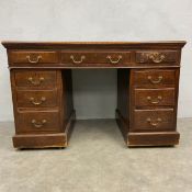 A C.1900 oak twin pedestal desk in three sections with blue leather lined top over an arrangement of