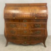 A 19th century Dutch mahogany bombe bureau with cylinder roll-top and brushing slide enclosing a