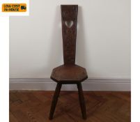 A C19th oak spinning chair with carved back and panel seat. H.93cm.