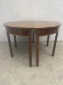 A 19th century figured and feather-banded mahogany d-end extending dining table with two leaves