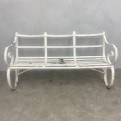 A late 19th century Regency style white painted wrought iron strap-work garden or outdoor bench with