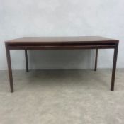 A mid-century Santos rosewood extending dining table with figured top and two integrated leaves