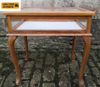 An Edwardian oak vitrine or display cabinet with hinged glazed top and lined interior on cabriole
