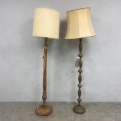 A 20th century turned and carved standard lamp with shade together with a similar brass example. H.