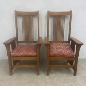 A pair of Arts & Crafts style 'Mission' oak hall armchairs each with with straight stick back and