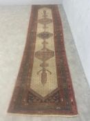 A Persian Sarab runner with central pole medallion in a patterned field over an oat ground with