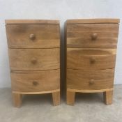 A pair of contemporary bow fronted hardwood bedside chests of three drawers raised on square tapered