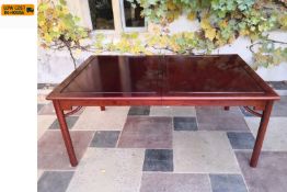 A contemporary Chinese lacquered teak extending dining table with two extra leaves. H.77 W.183 D.