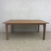 An Arts & Crafts style extending cherrywood dining table with dovetailed plank top and two