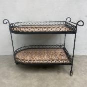 An early 20th century tiled two-tiered drinks trolley with wrought iron openwork gallery surrounds
