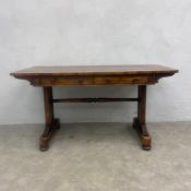 A 19th century William IV rosewood library table with figured top over two frieze drawers raised