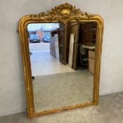 A 19th century carved giltwood overmantle mirror with Rococo style shell and foliate cresting over