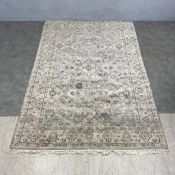 A Turkish Oushak carpet with scrolling foliate field over a grey ground within a repeating