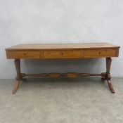 A C.1900 Continental satin walnut library table with three frieze drawers raised on flat stretchered