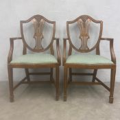 A pair of Hepplewhite style mahogany shield back armchairs. H.97 Seat height 45 W.56cm.