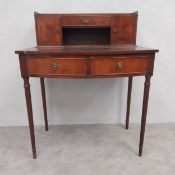 A 19th century style mahogany writing table or desk with fitted raised superstructure above frieze