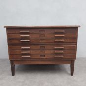 A vintage elm plan or architects chest of six drawers raised on tapered square section supports by