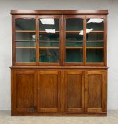 A 19th century mahogany library bookcase in three sections, the two upper sections with two pairs of