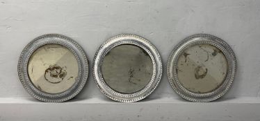A set of three vintage circular tin-framed wall mirrors with patinated plates. Dia.53cm each