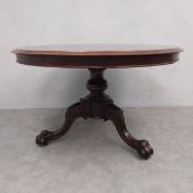 A mid 19th century mahogany dining table with tilt-top action on carved tripod pedestal base. H.74